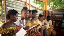 A group of children reading at class during the EAGER project.