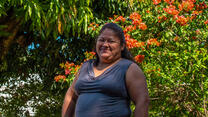 A woman poses for a portrait outside in El Salvador.