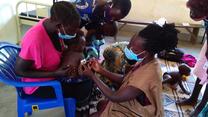 Esther, an IRC nutrition assistant, uses the mid-upper arm circumference measure (MUAC) to quickly identify if the child is at risk of malnutrition. When measured properly against a bare upper arm, the paper gauge provides a number and indicates the colour range. The green colour here is positive - the child is not showing signs of malnutrition.