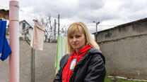 Tetiana standing in front of a clothes line full of laundry