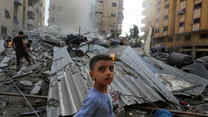 People assess the destruction cause by Israeli air strikes in Gaza City on October 7, 2023.