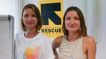 Ukrainian twins Maryana and Ruslana standing in front of the IRC logo