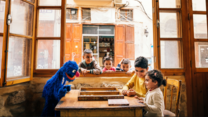 Promotional picture for Ahlan Simsim of Sesame Street character playing with children