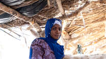 A woman poses for a photo outside in Mali.