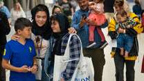 An Afghan family embraces after their reunited for the first time in years at the Salt Lake City Airport.