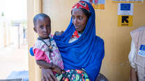Zeinab’s mother looks at her with care 