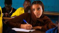 Gao, Mali. Samah, 15, looking at the blackboard while writing.