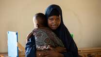 Shukri a Sudanese refugee in Kenya is holding her child