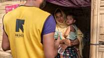 An IRC staff member speaks to a refugee and her child in Cox's Bazaar, Bangladesh.