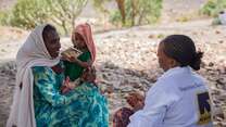 An IRC health worker prepares to administer a vaccine to a young child in Tigray, Ethiopia.