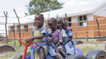Five children play at a playground in Ethiopia.