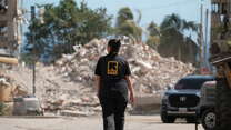  IRC staff members in La Guaira survey the destruction of the twin earthquakes on June 24.