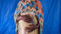 Portrait of Mariam* at Materity Ward in IRC clinic in Aboutengue refugee camp.