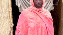 Hawa (45), poses for a photograph outside her shelter.