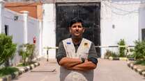 Dr Ahmed, arms crossed, looking at the camera. 