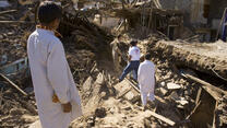 The IRC team had to hike over flattened houses and between precariously leaning walls to reach the village center.