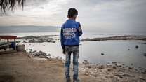 Fouad stands on the 'corniche' overlooking the Mediterranean Sea in Tripoli, Beirut where many boys sell CDs to tourists. 