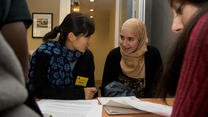 Volunteers work with refugees in an ESL class at the IRC resettlement office in New York