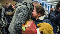 Alaa hugs her brother-in-law after he arrives at Sea-Tac International Airport