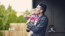 Adil with his son Steven outside their apartment