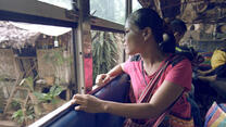 As a bus prepares to leave Mae La camp in Thailand, a Burmese woman looks out the window to say goodbye for the last time.