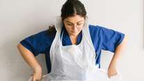 Anxhela Gradeci ties her apron