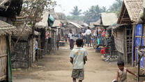 A boy walks through a camp for Muslims displaced by violence in Rakhine state, Myanmar