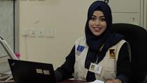 Bushra sitting at a desk with a computer