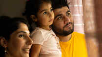 Maasom, Hiba and Nasrin look out the window together of their home in Hampshire.