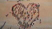 Together with refugees created a giant heart on Brighton Beach.
