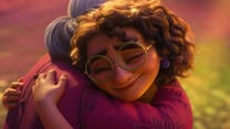 Mirabel and hugging her grandmother from Disney's Encanto