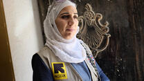 37-year-old Amira volunteers at a health clinic ru