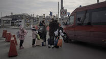 A family meets at the border crossing point of Medyka, Poland.