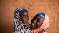  8-year-old Fatima embraces her mother, Habiba, while getting ready to go to school.  Captured by Etionsa Yvonne.