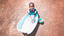 Young boy washes hands