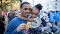 Ethiopian runner Tolassa Elemaa with his daughter after completing the New York City Marathon on Nov. 7, 2018