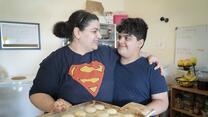 10-year-old Yousif holds a plate of shakar lama cookies with his mom, Taghreed