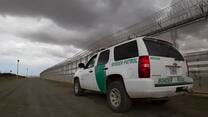 U.S. Border Patrol vehicle at a border fence near San Diego