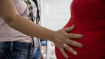 An IRC health worker examines a pregnant Venezuelan women