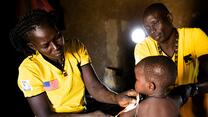 Health workers in South Sudan measure a toddler's arm for signs of malnutrition. 