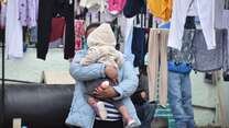 Alma, an asylum seeker from Guatemala, and her daughter wait for their laundry to dry in the outdoor living space of a shelter in Ciudad Juarez. 