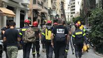 Firefighters walk down a street in Beirut, Lebanon after the Aug. 4 explosion