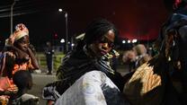 A young woman carries a mattess and other belongings as people flee the border city of Goma for the Rwandan border after the May 22 eruption of Mt. Nyiragongo.