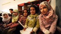 Four young Syrian girls sit in a makeshift school in Berkayel, Lebanon. 