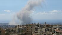 The skyline of Beirut with a huge plume of smoke in the background. 