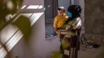 Zulaykha, an Afghan mother of four, holds her one-year-old son 