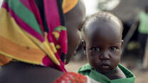 A close up of a mother holding her baby son 
