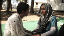 Lena Headey, who plays Cersei Lannister on Game of Thrones, talks with Afghan refugee Rehanna, age 27, holding her hands