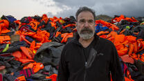 Mandy Patinkin with lifejackets used by refugees