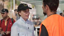 Piper Perabo speaks with a refugee in Greece